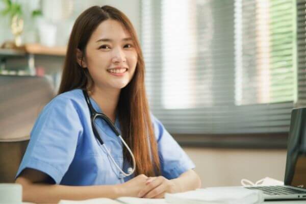 Nurse smiling at her office